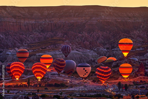Flying hot air balloons in Anatolia, Kapadokya at sunrise. National park in Nevsehir, Goreme