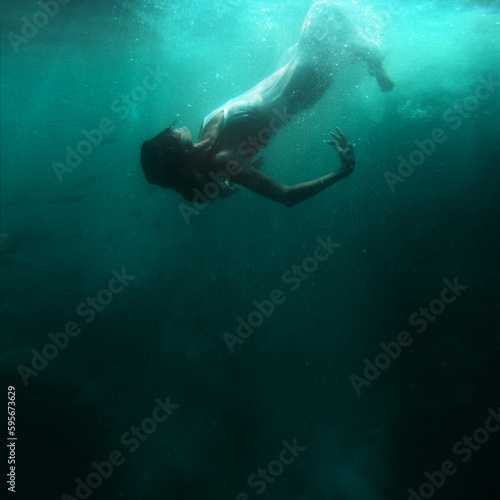 Woman floats underwater, dream fantasy