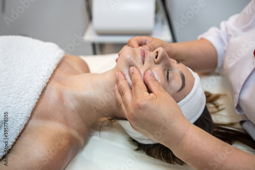 girl client is lying down for a facial massage in the best spa salon in town.