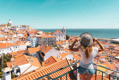 Traveler Woman, tourist on balcony looking at panoramic view of Lisboa- Tourism, vacation, travel in Portugal