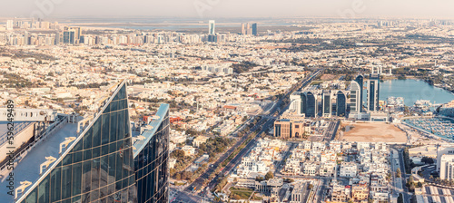 Aerial view of a wide street with car traffic among skyscrapers with hotels and residential real estate blocks in Abu Dhabi, UAE