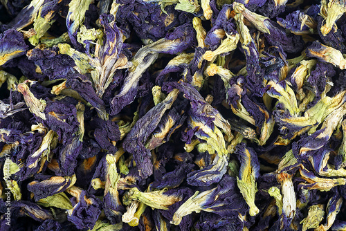 Dried leaves and buds of clitoria are ternate as background, top view. Anchan, blue tea.