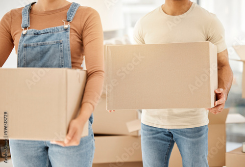 The time felt right for a new start. Closeup shot of an unrecognisable couple carrying boxes while moving house.