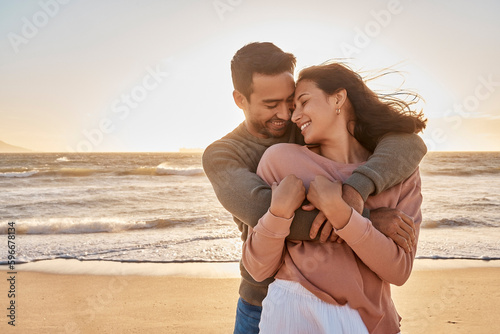 Young diverse biracial couple having fun at the beach together. Young diverse biracial couple having fun at the beach together.