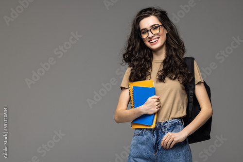 Laughing female student with backpack isolated on white background for cut out