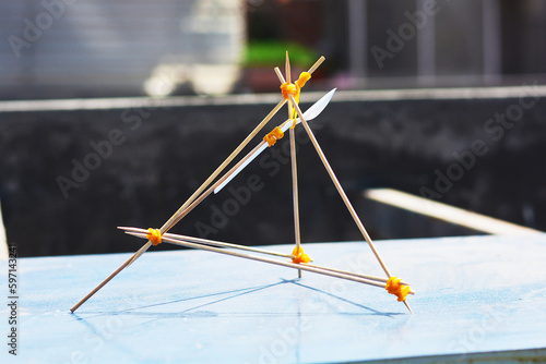 Handmade catapult from wooden sticks, elastics and a spoon.