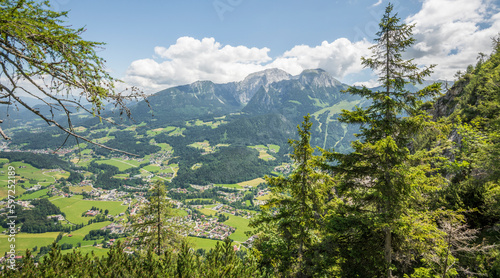 Beautiful summer view of Bavarian Alps in Berchtesgaden National park. Salzalptour. Pine trees in the forground, majestic mountains in the background.