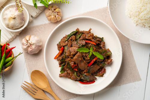 Stir fried sliced Beef with Holy Basil in white plate.Thai famous food (Pad Kra pao).Top view