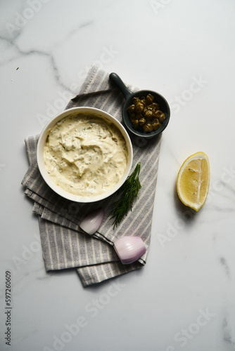Classic Tartar Sauce dip in the bowl. Mayonnaise with dill and capers plus lemon, shallot onion. Worcester sauce and Dijon Mustard. 