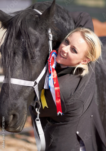 Winner, sports and portrait of woman and horse for equestrian, competition and celebration. Happy, smile and animal show with female jockey and stallion with ribbon for achievement and performance