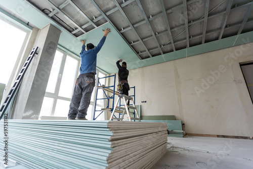 Construction worker installation ceiling work