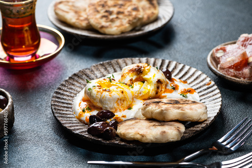 Cilbir or Turkish Eggs. mezze: poached eggs topped over herbed greek yogurt, then drizzled with hot spiced paprika olive oil. Traditional Turkish breakfast with rahat