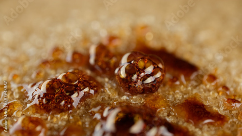 Caramelizing brown sugar using gas torch, close up