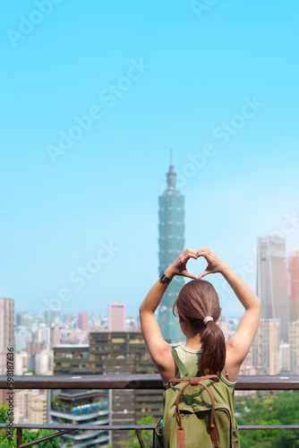woman traveler visiting in Taiwan, Tourist looking Taipei City during sightseeing and hiking at Elephant Mountain or Xiangshan, landmark and popular attractions. Asia Travel, vacation and Trip concept