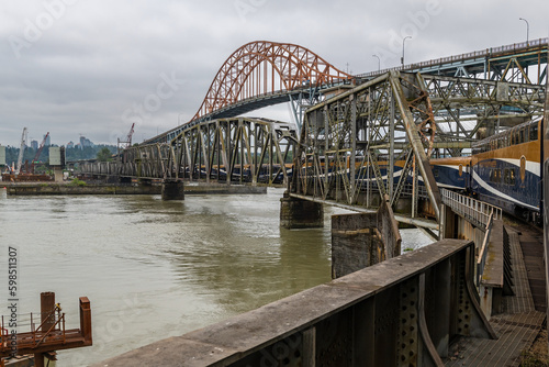 Rocky Mountaineer train crossing Pattullo arch bridge and Fraser River between New Westminster and Surrey, British Columbia, Canada.
