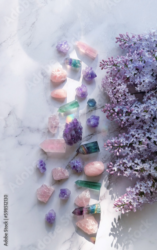 minerals set and lilac flowers on marble background. gemstones for esoteric spiritual practice. Healing magic Crystal Ritual, Witchcraft for Relax, harmony, Good energy. top view. template for design
