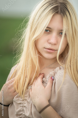Portrait of a young beautiful blonde girl in the open air.