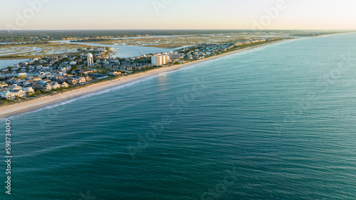 Aerial view of Wrightsville Beach, NC homes during a sunrise.