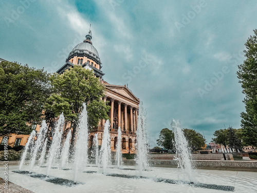 Illinois State Capitol Building in Springfield, Illinois, USA. Water fountain in front of the building with blue skies above.