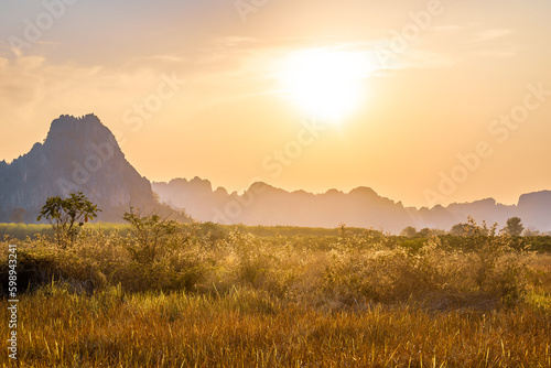 Sunset at the field with limestone mountain range, travel view at Noen Maprang district, Phitsanulok, Thailand