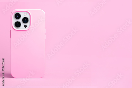 pink phone case mockup. iPhone 14 pro max and 13 mock up back view isolated on pink background, banner with place for text on the right in monochrome colors