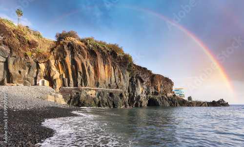 Rainbow over Formosa black beach in Madeira, Portugal
