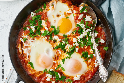 Shakshouka, eggs poached in sauce of tomatoes, olive oil. Mediterranean cousine.
