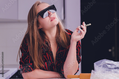 Swag girl sniffing cocaine imitation, flour . blonde Woman stoned. White background.