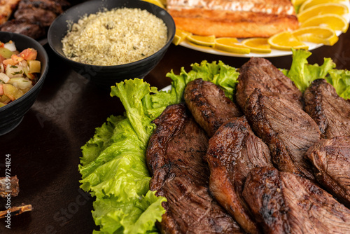 Churrasco - barbecue rodizio - Steak Ancho, Picanha, Tuscan Sausage, chicken, garlic bread, salmon, farofa and rice