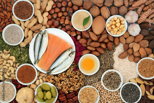 Healthy heart food ingredients high in lipids containing unsaturated good fats for low cholesterol levels with nuts, seeds, dairy, fish, vegetables, legumes and grain. Top view.