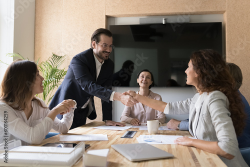 Happy business partners reached agreement shake hands after making profitable commercial deal. Formal meeting, sell services, congratulate promoted employee, express appreciation for great cooperation