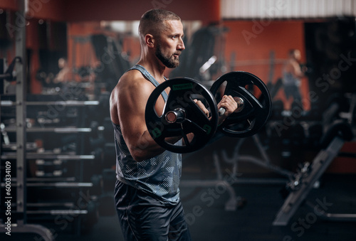 Bearded strong athletic fitness men pumping up arm muscles workout barbell curl fitness concept background - muscular bodybuilder men doing bodybuilding biceps exercises in gym