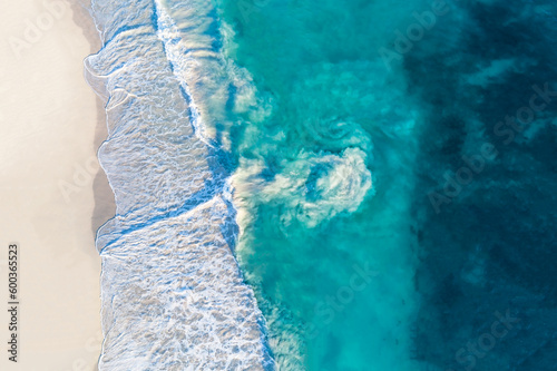 Aerial view of sandy beach with waves and riptide current. Sunny day in summer with transparent tropical blue water. Travel to Alkimos Beach, Western Australia, Australia. Top view. Coastal, Seascape