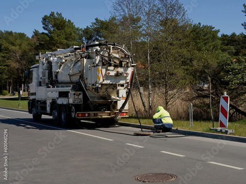 Specially equipped truck for city sewer cleaning. Cleaning sewer manholes. Selective focus.