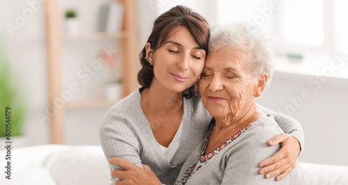 Happy elderly woman with her daughter at home