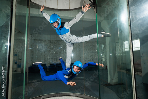 A man and a woman enjoy flying together in a wind tunnel. Free fall simulator