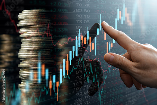 Increased return on investment. Stacked coins and data of financial market. Analyst pointing candlestick chart .