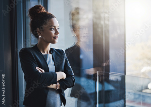 Business woman, window and thinking for vision, goals and future of career with ideas, mission and mindset. Young businesswoman, focus and ambition in workplace with memory, reflection and dream