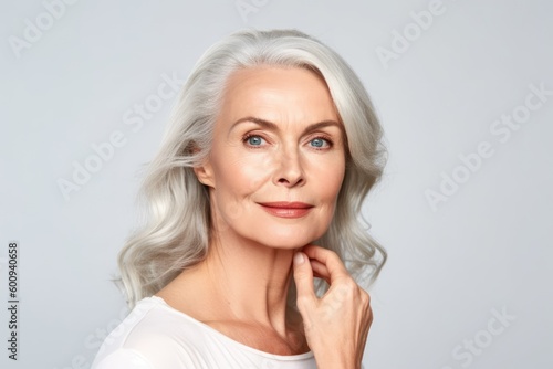 Beautiful gorgeous 50s mid aged mature woman looking at camera isolated on white. Mature old lady close up portrait. Healthy face skin care beauty, middle age skincare cosmetics. Generative AI