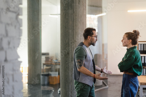 Colleagues arguing in office, problems at work.