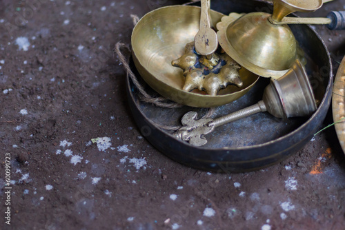 Hindu puja ritual items made of brass and other metals kept together. Kasar or gong bell, ghanta musical instruments and panch pradeep are seen which are mostly used in religious rites.