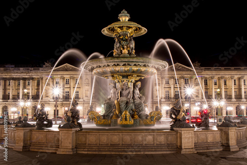 Fountain of the Seas located in Place de la Concorde in central Paris, France, at night - Motion blur achieved with long exposure on a fountain with many golden statues of Greek gods