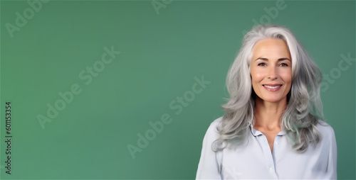 Beautiful middle aged mature woman in 50s looking at camera isolated on mint background, AI generative content.
