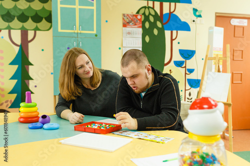 a psychologist is engaged with an autistic man with mental disabilities