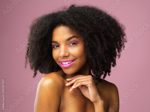 Face, hair care and smile of black woman with makeup in studio isolated on pink background for skincare. Hairstyle portrait, lipstick cosmetics and African female model with salon treatment for afro.