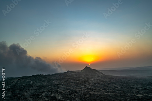 Erte Ale, a continuously active basaltic shield volcano, Afar Region of northeastern Ethiopia. It is in the Afar Depression. People silhouettes watching sunrise. An improved edit.