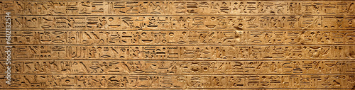 Old Egyptian hieroglyphs on an ancient background. Wide historical background. Ancient Egyptian hieroglyphs as a symbol of the history of the Earth.