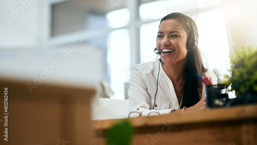 Laughing, virtual assistant or happy woman in call center consulting, speaking or talking at help desk. Smile, friendly or funny sales consultant in telemarketing customer services or telecom company