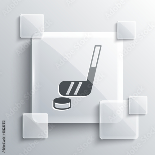 Grey Ice hockey stick and puck icon isolated on grey background. Square glass panels. Vector