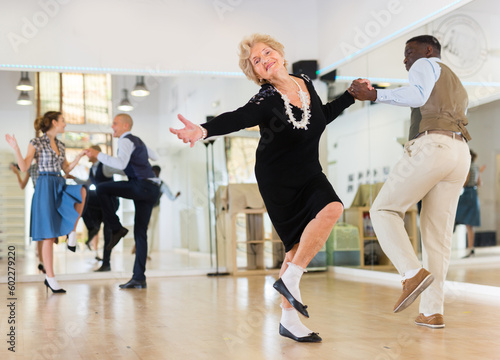 Senior womaSenior woman and man dancing swing in studion and man dancing swing in studio